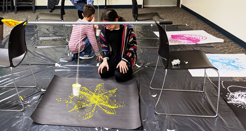 Kids making pendulum paintings