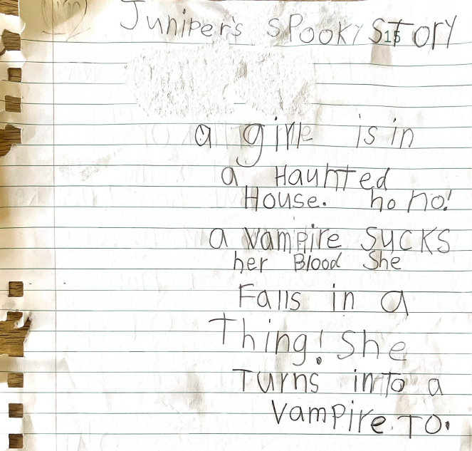 The hand-written version of "Juniper's Spooky Story" with text in large, blocky letters suggesting a very young age for the author.